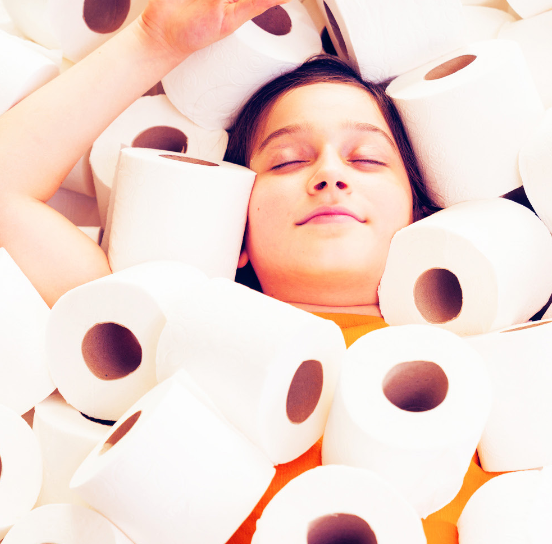 A woman looking relaxed, half buried in rolls of Regina.
